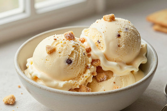 Two generous scoops of sugar cookie ice cream in a shallow ceramic bowl, softly melting at the edges