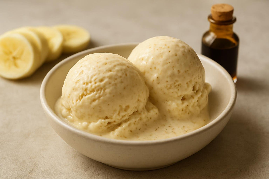 Scoops of vanilla banana cinnamon custard ice cream in a ceramic bowl