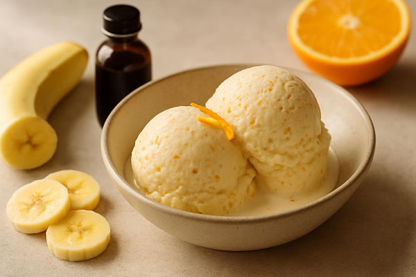 Scoops of vanilla banana orange custard ice cream in a ceramic bowl