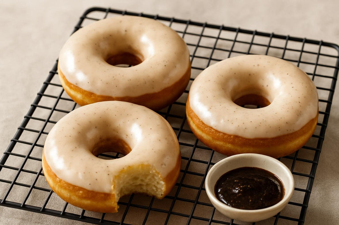 Doughnuts finished with vanilla bean glaze on a cooling rack
