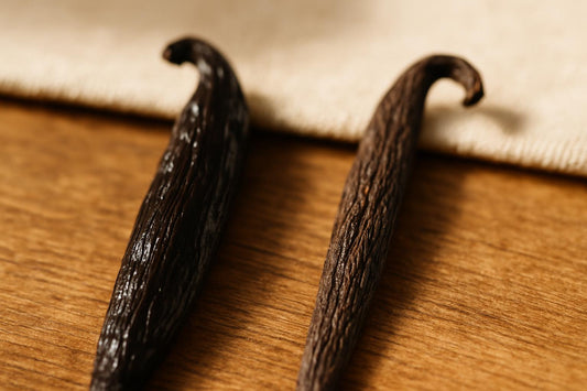 Grade A and Grade B vanilla beans side by side showing moisture content differences in texture and appearance
