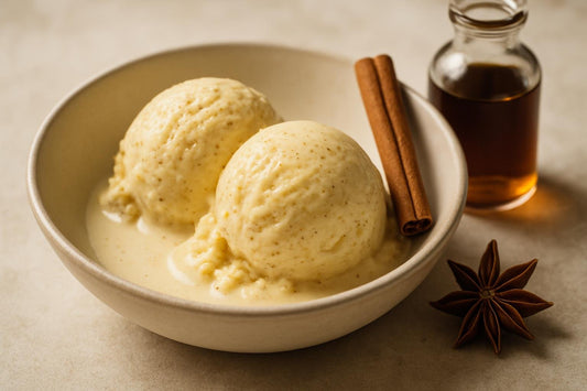 Scoops of vanilla chai spice lemon custard ice cream in a ceramic bowl