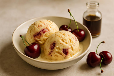 Scoops of vanilla cherry cinnamon custard ice cream in a ceramic bowl