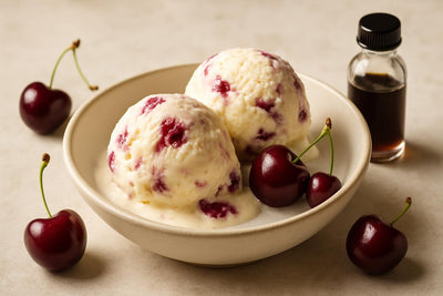 Scoops of vanilla cherry custard ice cream in a ceramic bowl
