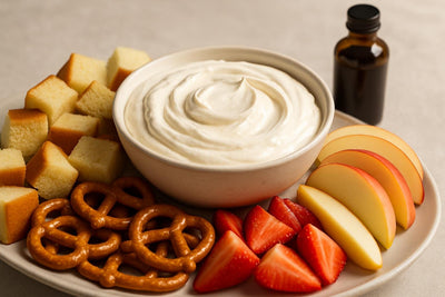 Bowl of vanilla cream cheese dip with brioche, pretzels and fruit