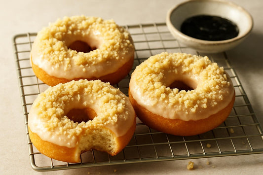 Doughnuts finished with vanilla crumble on a cooling rack
