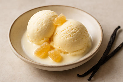 Scoops of vanilla ginger custard ice cream in a ceramic bowl