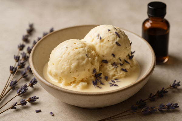 Scoops of vanilla lavender cardamom custard ice cream in a ceramic bowl