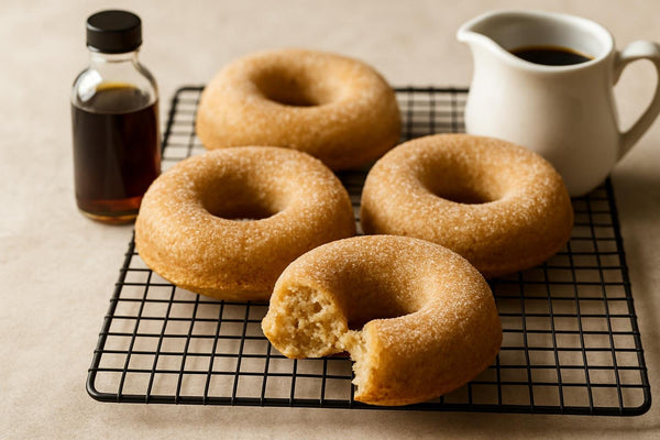 Vanilla Maple Cardamom Cake Doughnuts on a cooling rack
