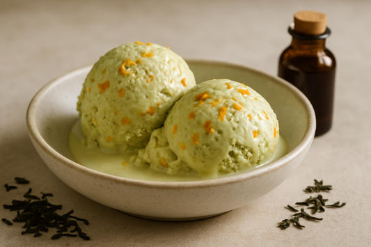 Scoops of vanilla matcha orange custard ice cream in a ceramic bowl