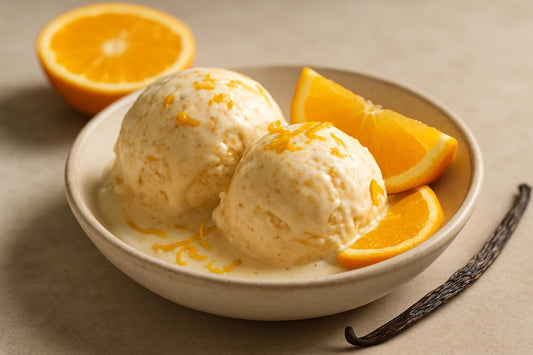Scoops of vanilla orange cinnamon custard ice cream in a ceramic bowl