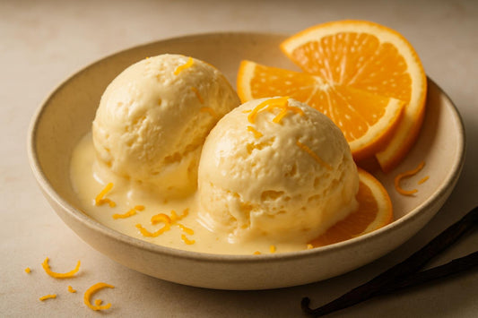 Scoops of vanilla orange custard ice cream in a ceramic bowl