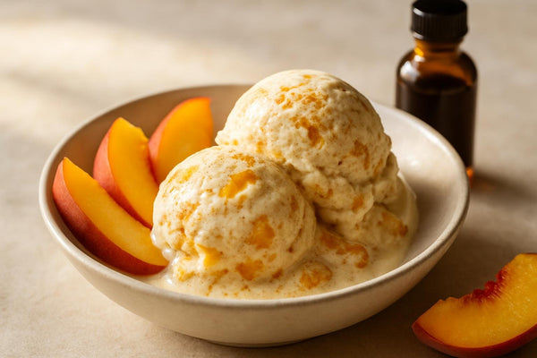 Scoops of vanilla peach cinnamon custard ice cream in a ceramic bowl