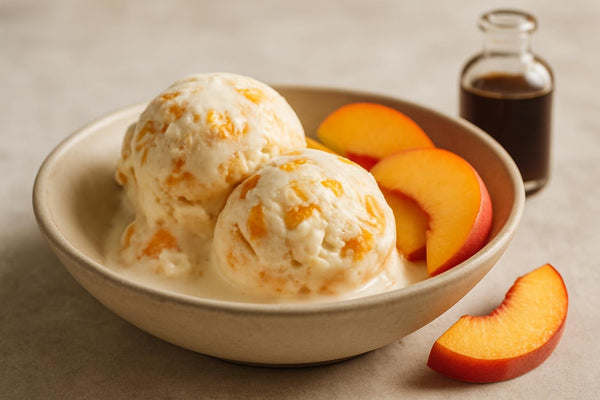 Scoops of vanilla peach ginger custard ice cream in a ceramic bowl