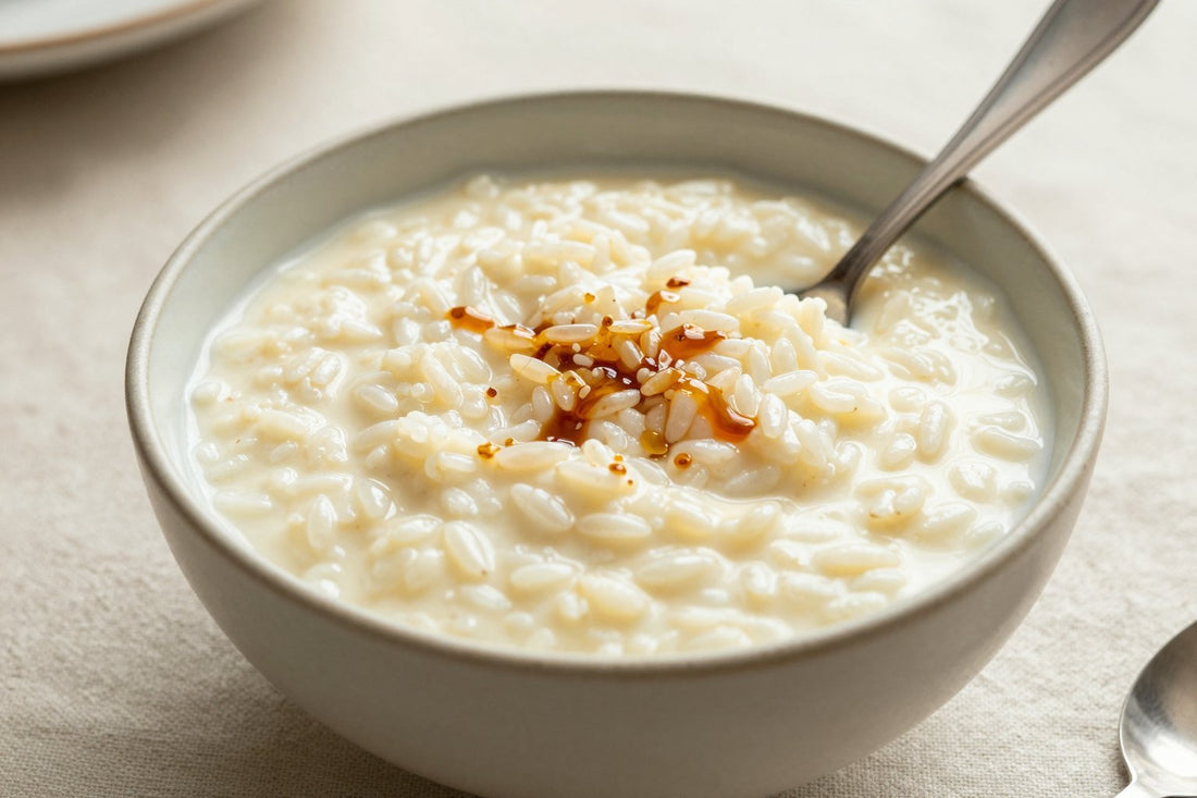 Creamy vanilla rice pudding in a small ceramic bowl with a spoon, garnished as in the recipe