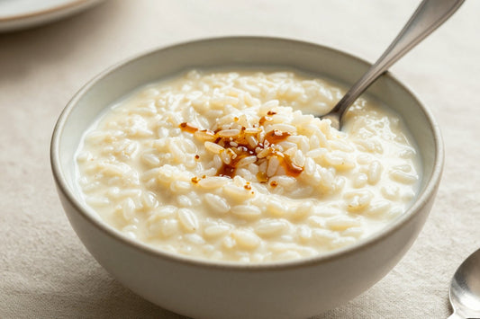 Creamy vanilla rice pudding in a small ceramic bowl with a spoon, garnished as in the recipe