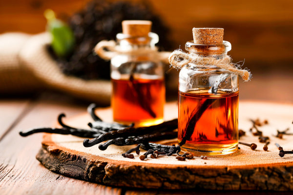 Glass jars of vanilla beans steeping in alcohol to make pure vanilla extract