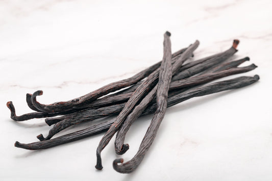 Supple vanilla beans stored in sealed glass jar in dark cabinet demonstrating proper vanilla bean storage techniques