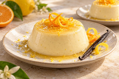 Vegan Citrus Vanilla Panna Cotta, unmolded on a plate with vanilla beans