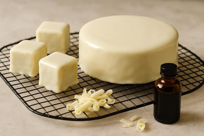 Cake coated in glossy white chocolate ganache icing