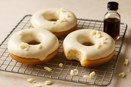 Doughnuts finished with white chocolate glaze on a cooling rack