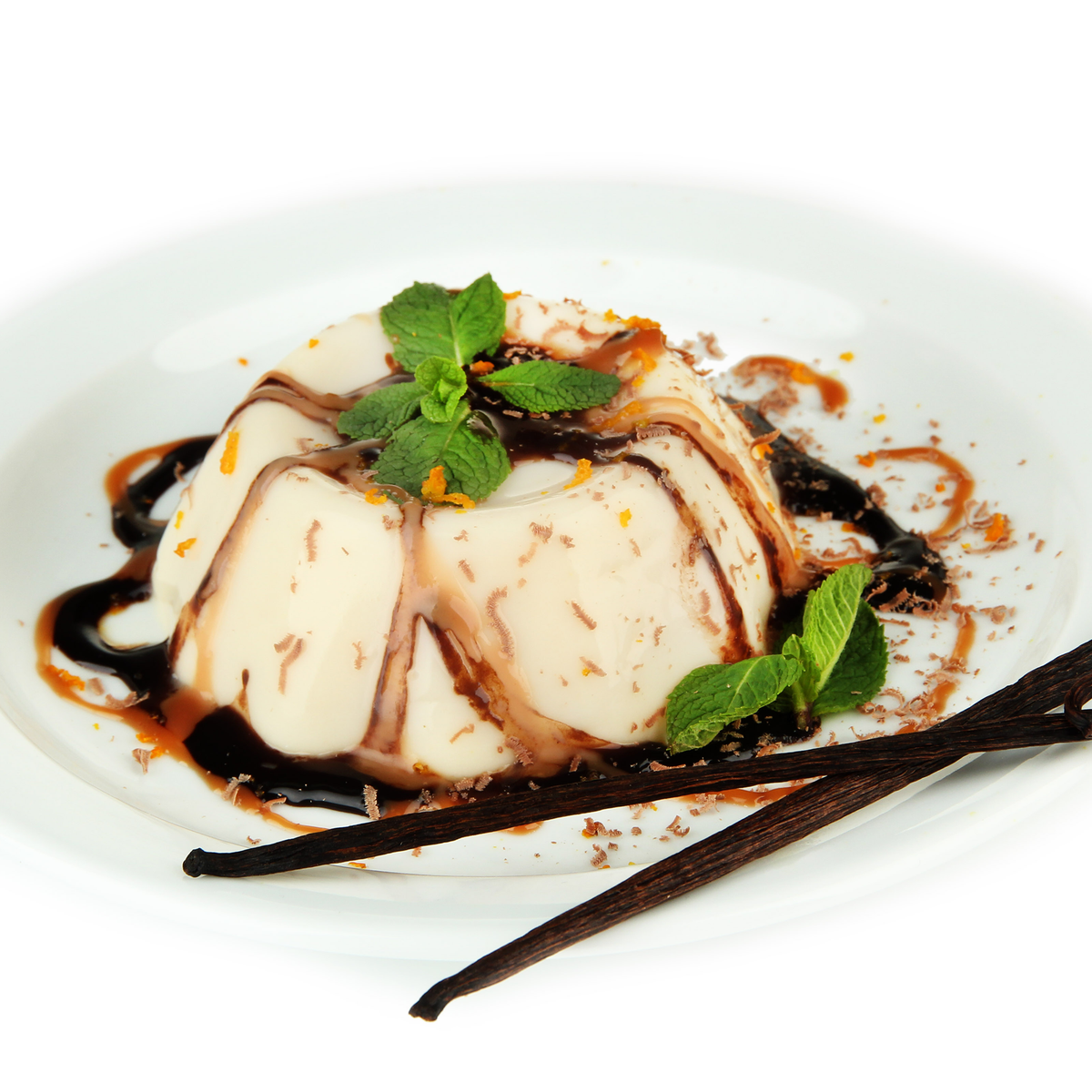 A plated dessert of vanilla ice cream or custard topped with chocolate sauce, mint leaves, and orange zest, served on a white plate with vanilla bean sticks on a white background.